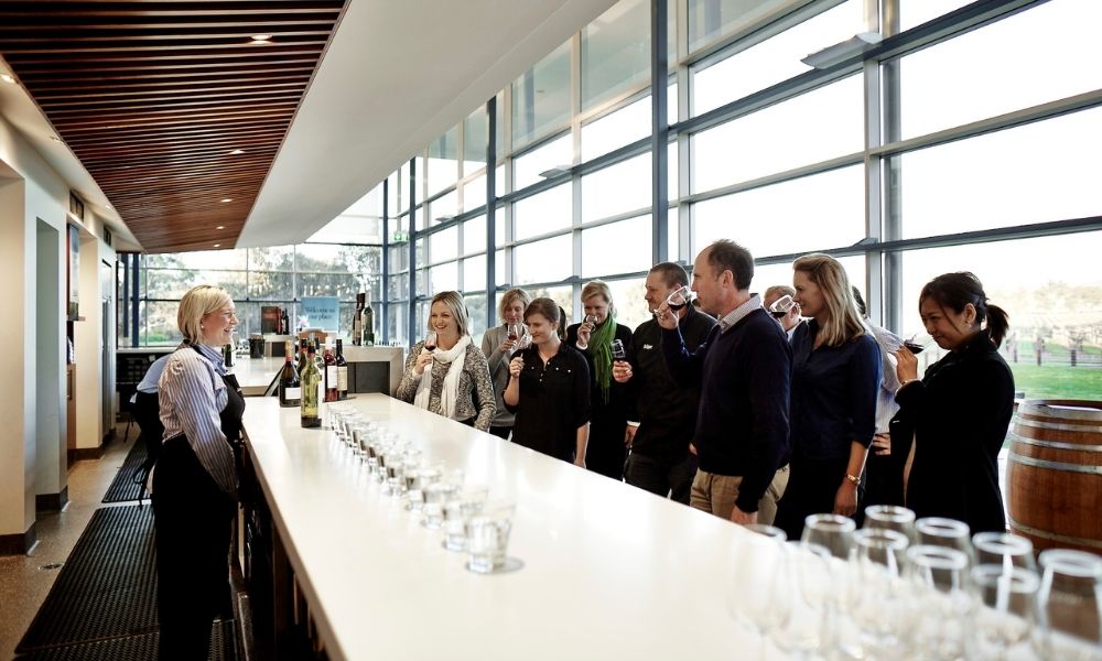 group of people sniff and taste wine