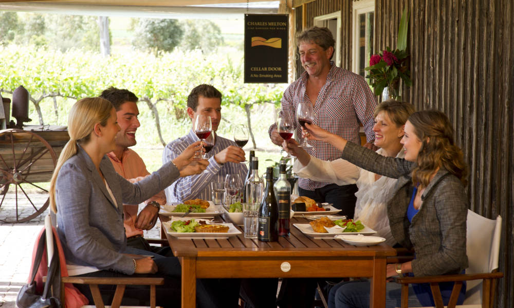 group of people enjoying a wine over lunch
