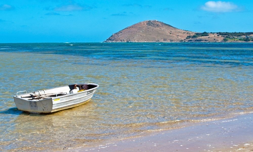 boat sits in shallow waters of Encounter Bay