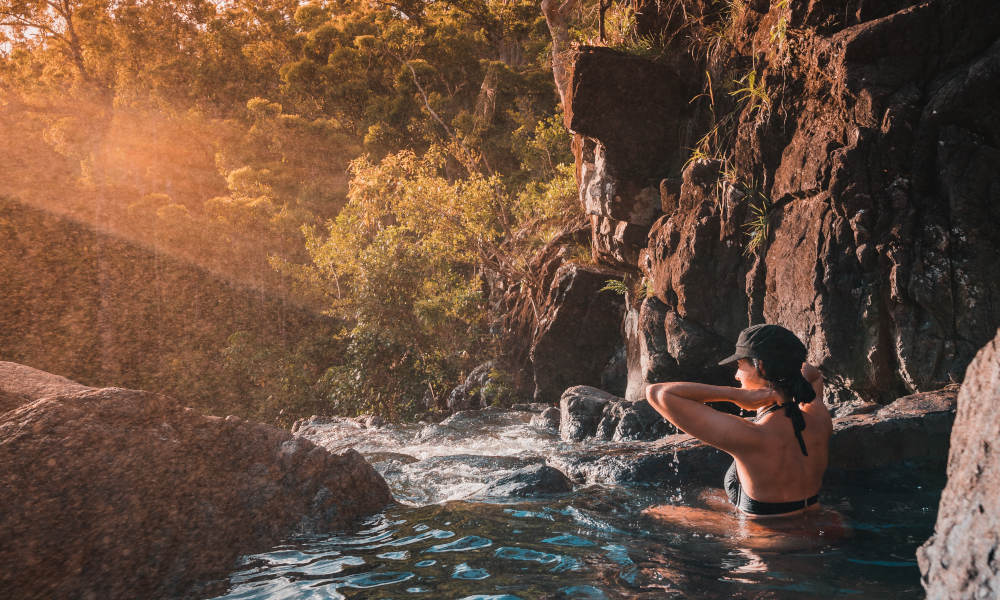 lady enjoying time in waterfall pool