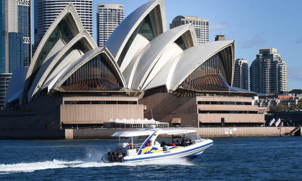 speed boat in front of opera house